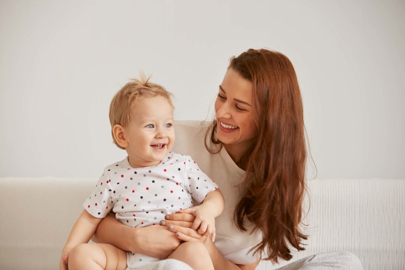Young Mother With Her One Years Old Little Son Dressed Pajamas Are Relaxing (2)